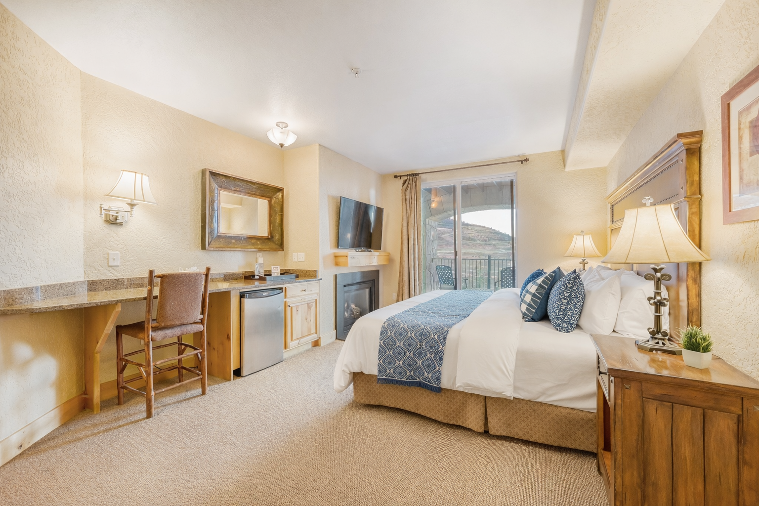 Relax in this spacious master suite featuring a king bed and handcrafted wood furniture. A serene retreat designed for ultimate comfort and a restful night's sleep.