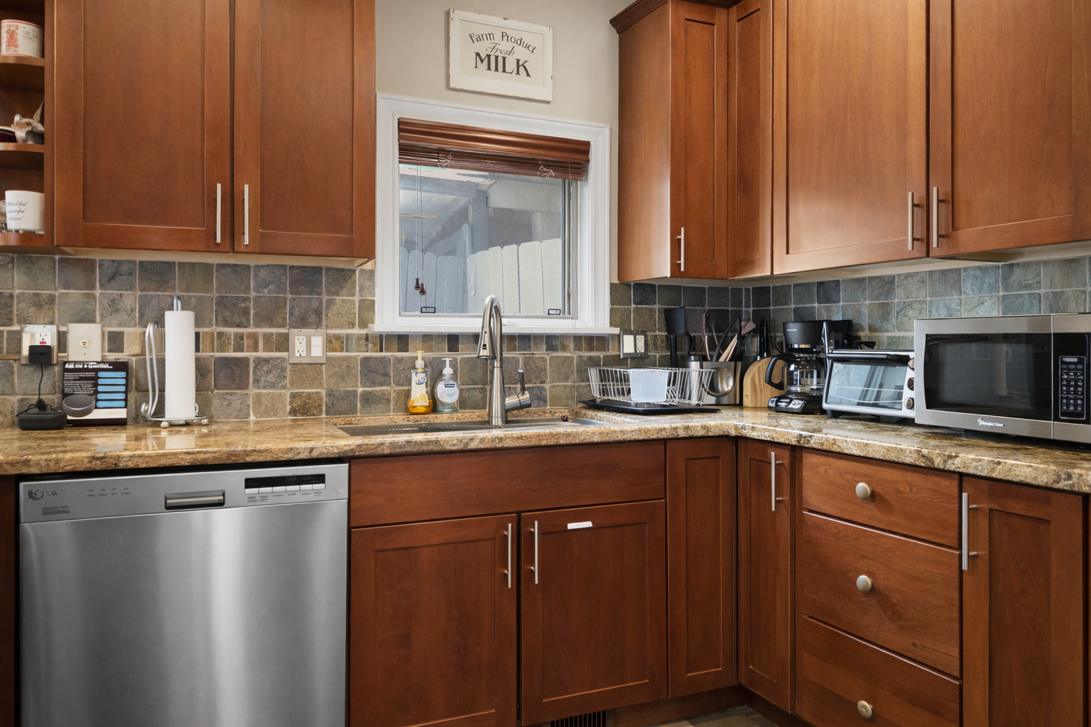 Your fully equipped kitchen features warm wood cabinetry, granite countertops, and modern appliances for preparing delicious home-cooked meals.