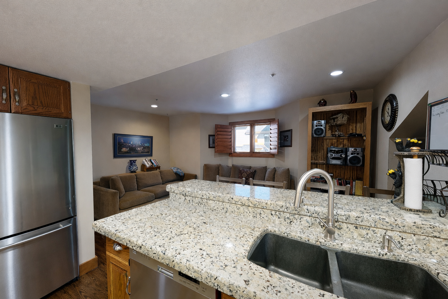 Enjoy this open-concept living area with a fully equipped kitchen and comfortable seating. Perfect for relaxing after a day exploring Park City's mountains.