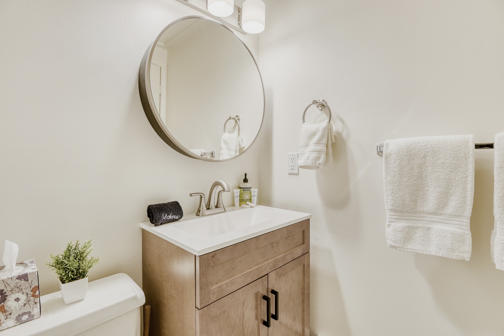 Step into your private sanctuary featuring warm wood vanity, plush towels, and thoughtful amenities for your daily refresh.