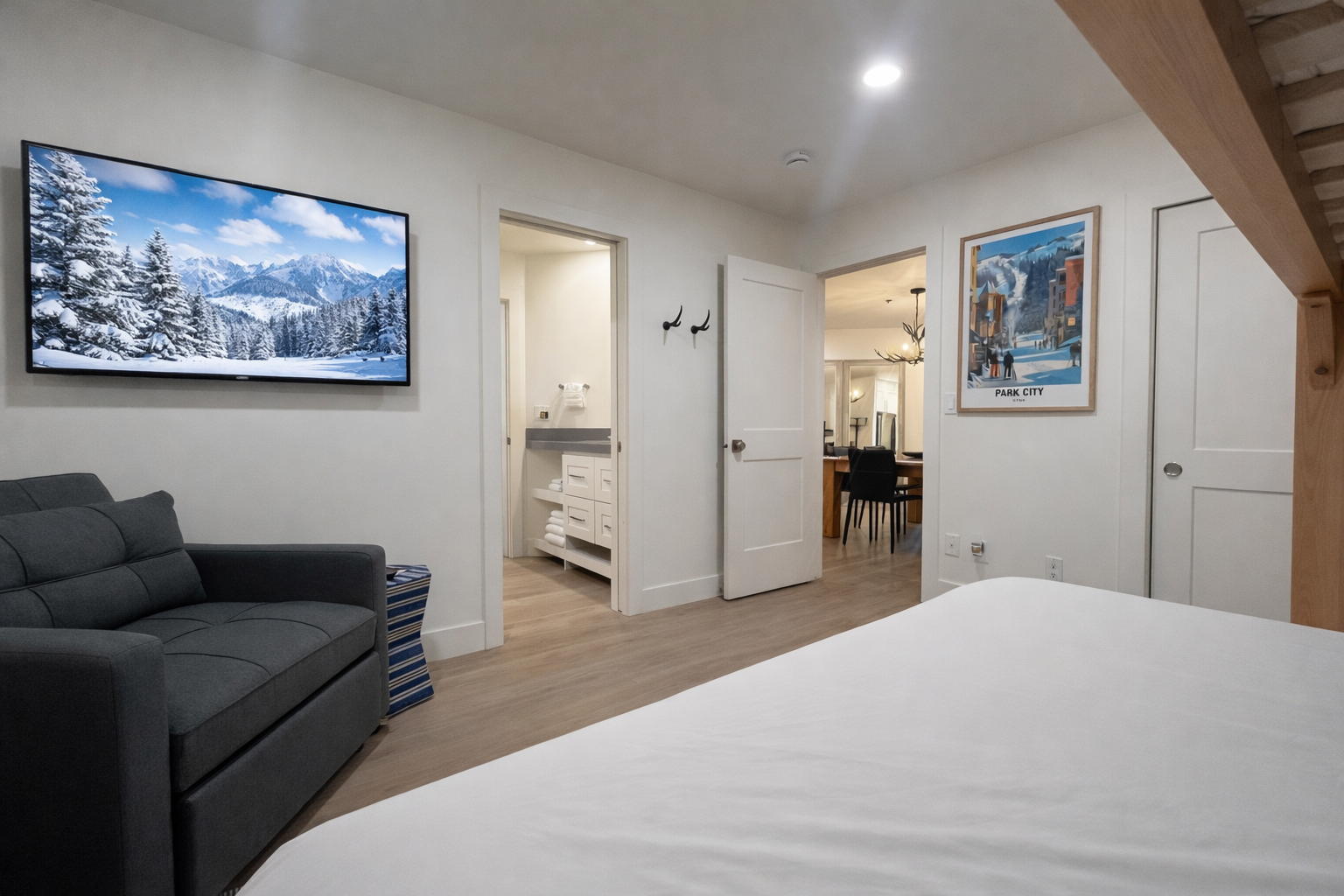 Relax in your bright, modern living space with a large flat-screen TV and comfortable seating, perfect for unwinding after exploring the area.