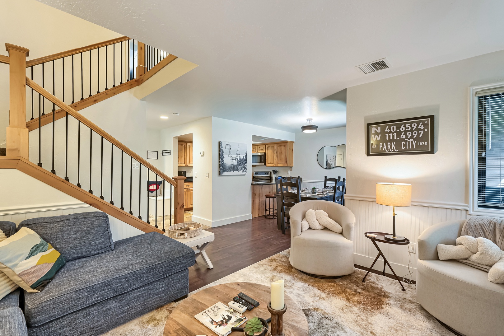 Sink into soft seating in this open, light-filled living area where warm wood tones and thoughtful touches create an inviting space to unwind after your mountain adventures.