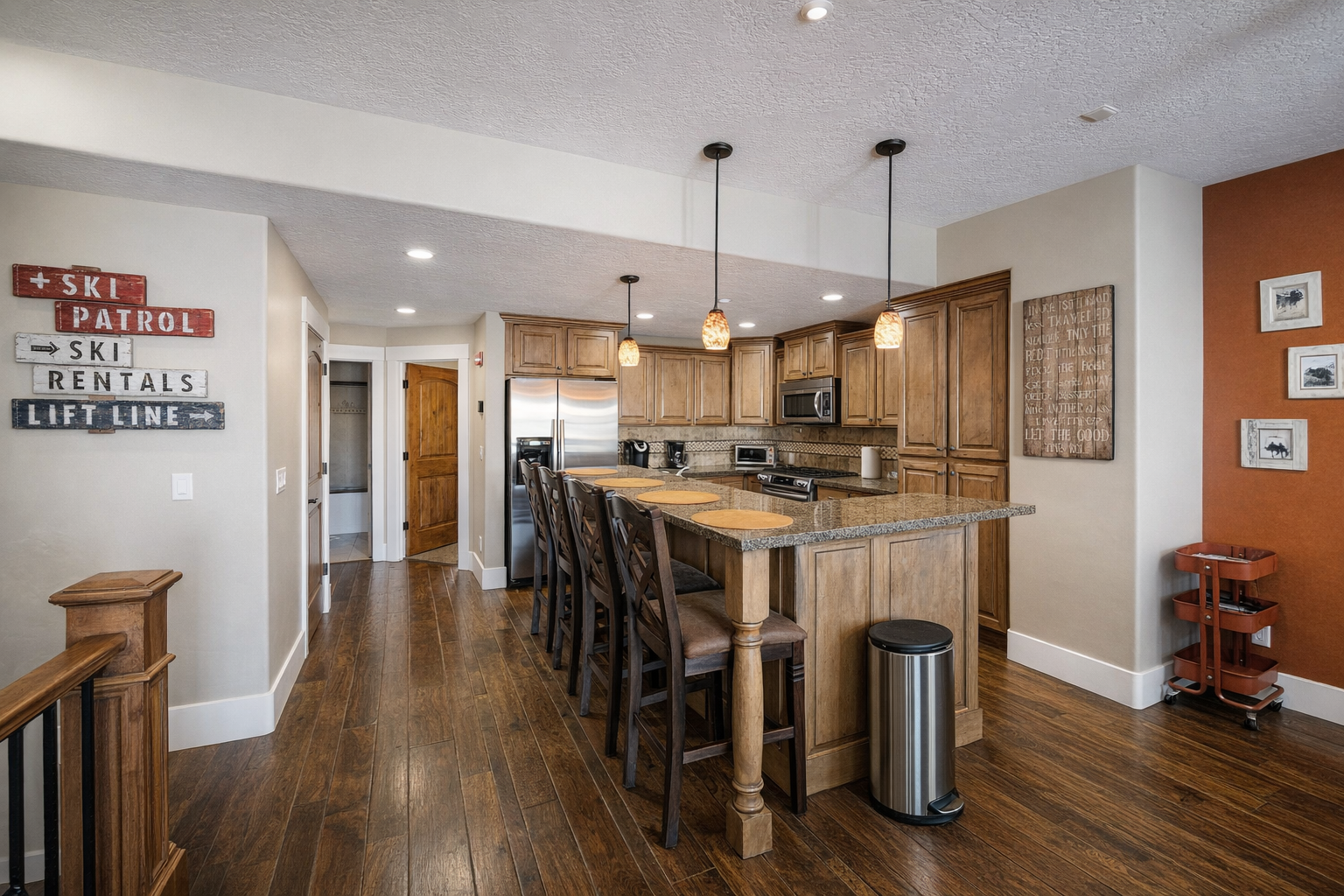 Prepare a gourmet meal in this warm, inviting kitchen featuring rich wood cabinetry and a spacious breakfast bar with seating for four.