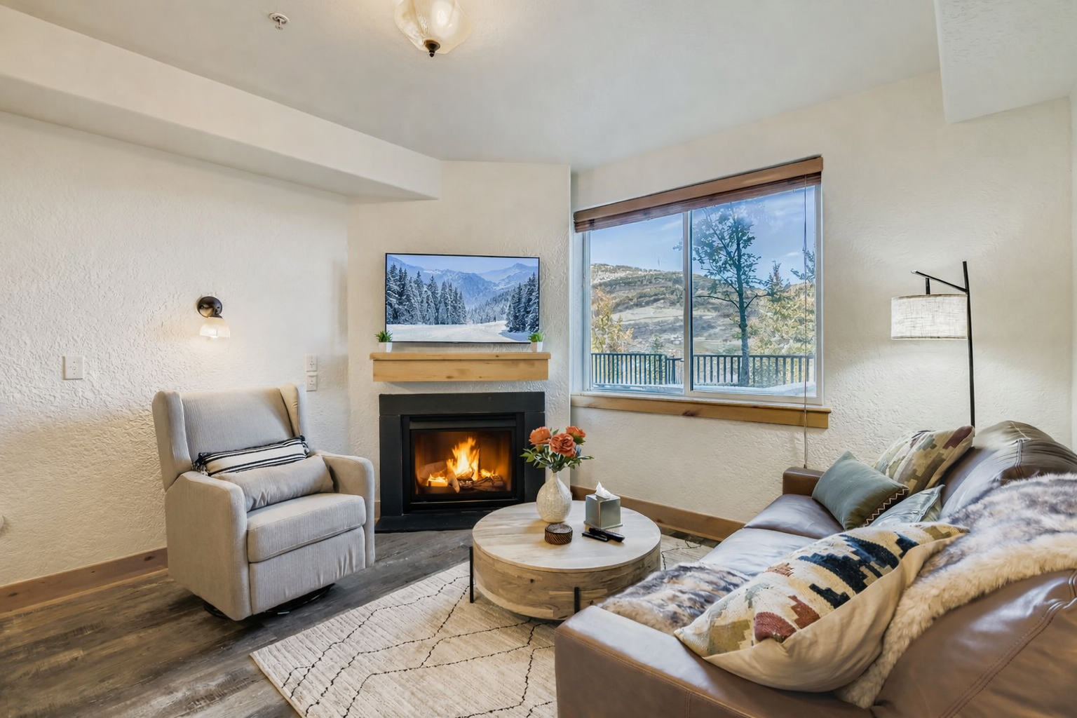 Cozy up by your crackling fireplace with mountain views stretching beyond the windows, perfect for relaxing evenings.