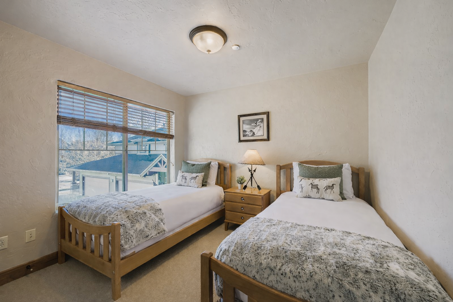 Your comfortable twin bedroom features two cozy single beds with soft linens, warm lighting, and a peaceful view to help you rest after your adventures.