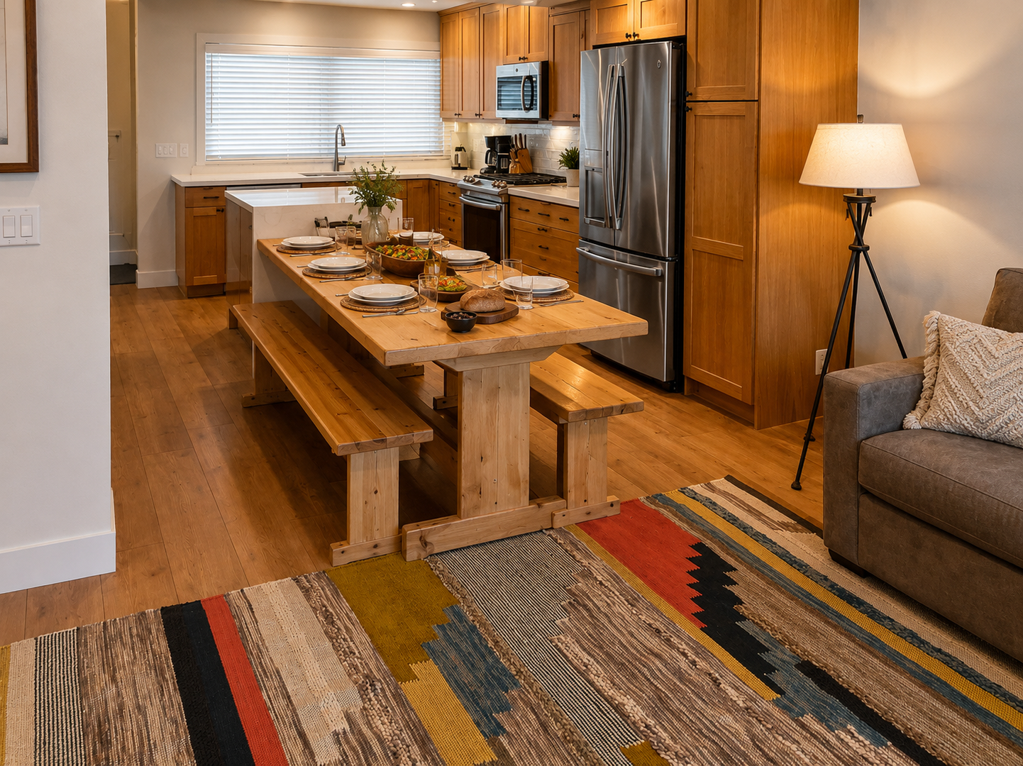 Prepare meals in our fully equipped kitchen, featuring a large island with bar seating, modern stainless steel appliances, and a stylish two-tone design. All the essentials for a great stay.