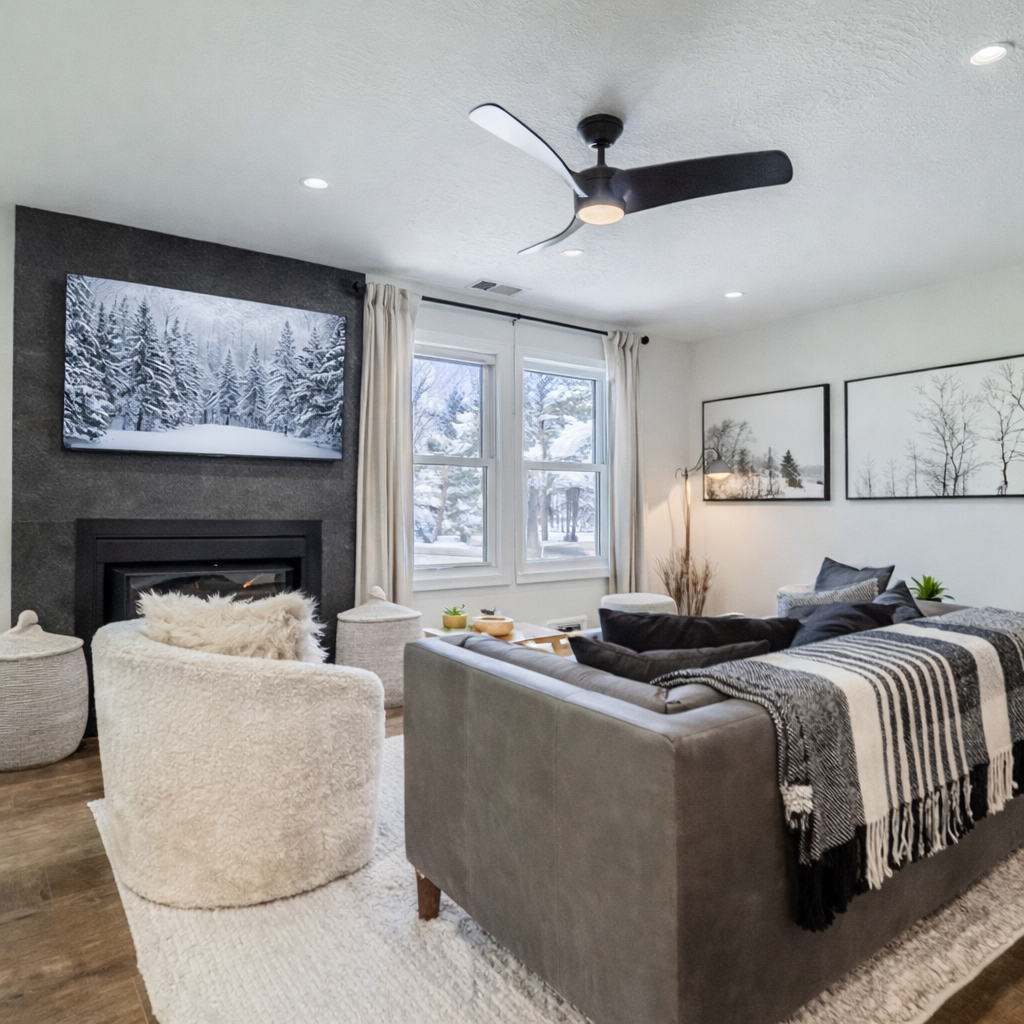 Sink into plush furnishings by your cozy fireplace while enjoying winter views through large windows in this thoughtfully designed living space.