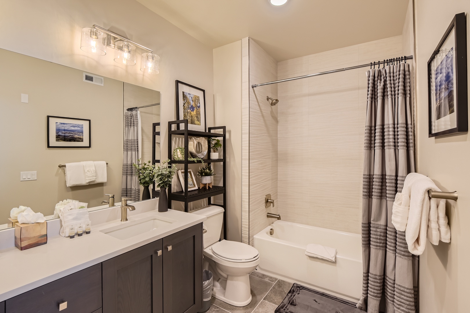 Step into your private retreat with modern finishes and thoughtful touches. Fresh towels await, while natural light brightens the sleek vanity and spacious tub—perfect for unwinding after exploring.