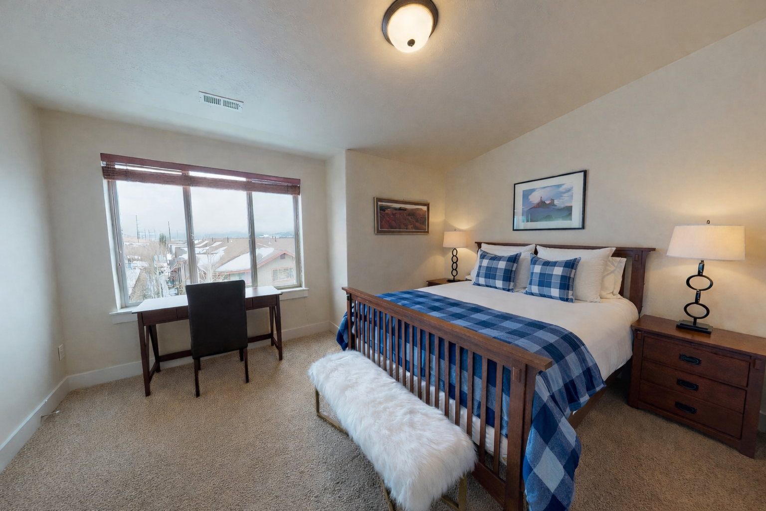 Drift off peacefully in your cozy bedroom with plush bedding and a workspace by the window for morning coffee and planning your day.