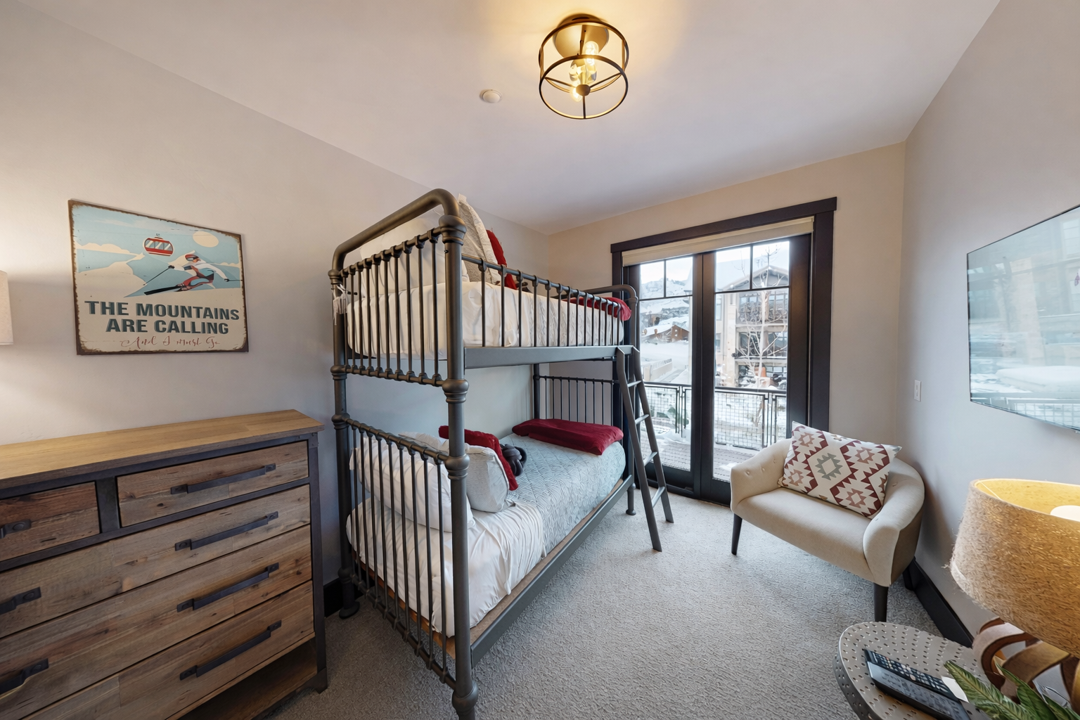 Maximize your stay in this bright, modern guest room. Offering a sturdy twin-over-twin metal bunk, ample storage, and prime local views, it’s a cozy and organized retreat.