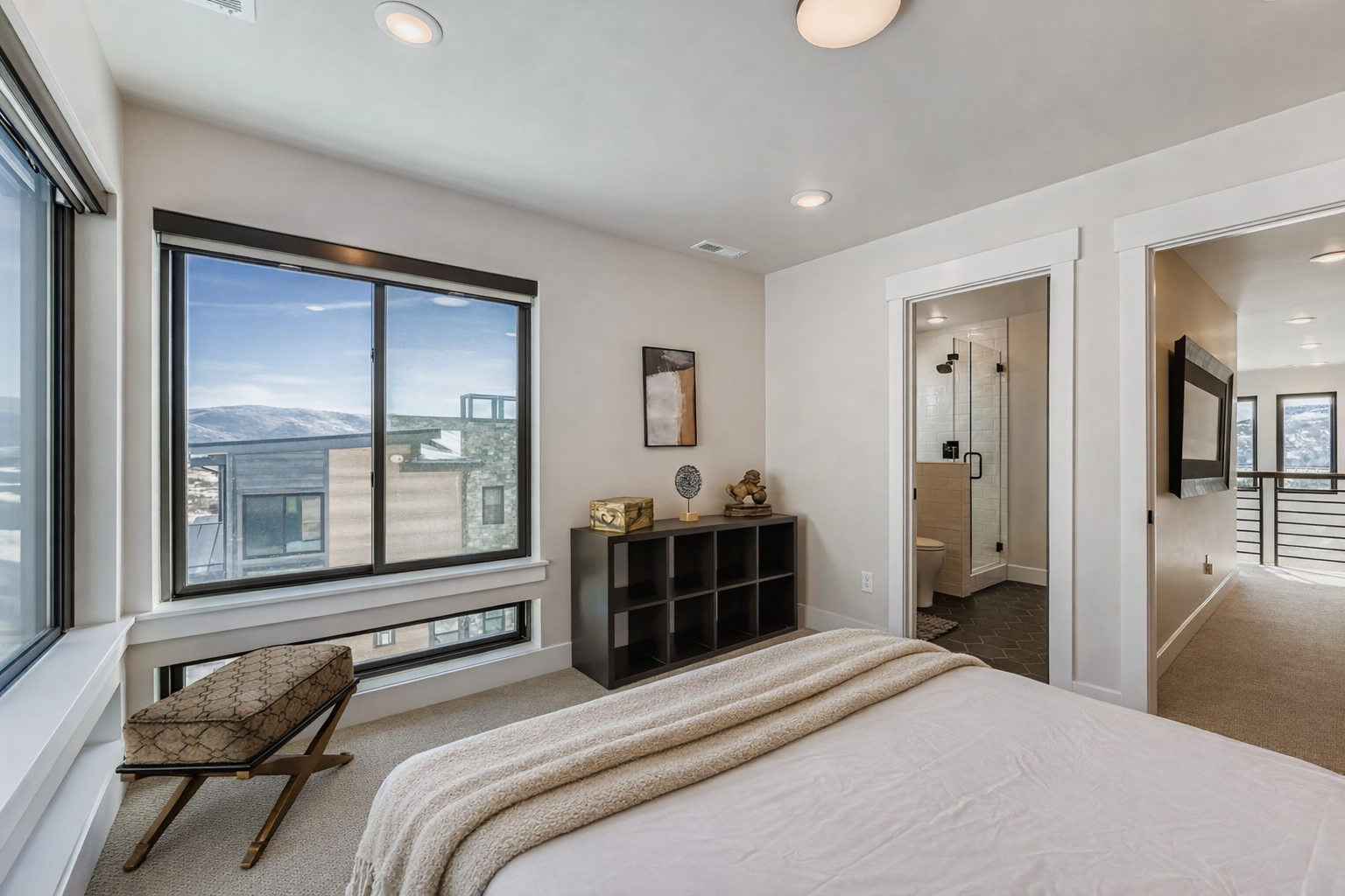 Unwind in your serene bedroom featuring a cozy reading chair by the window and thoughtful storage solutions, with your private ensuite bathroom just steps away.