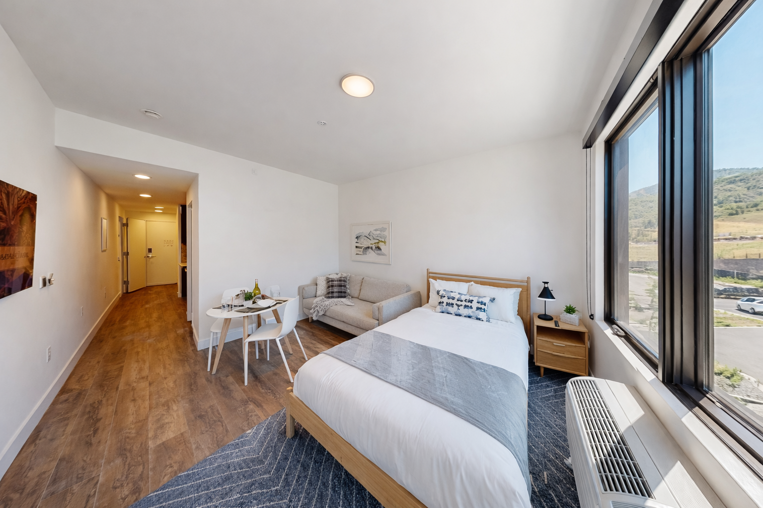 Retreat to this modern studio featuring a comfortable queen bed, a charming dining nook, and a cozy seating area.