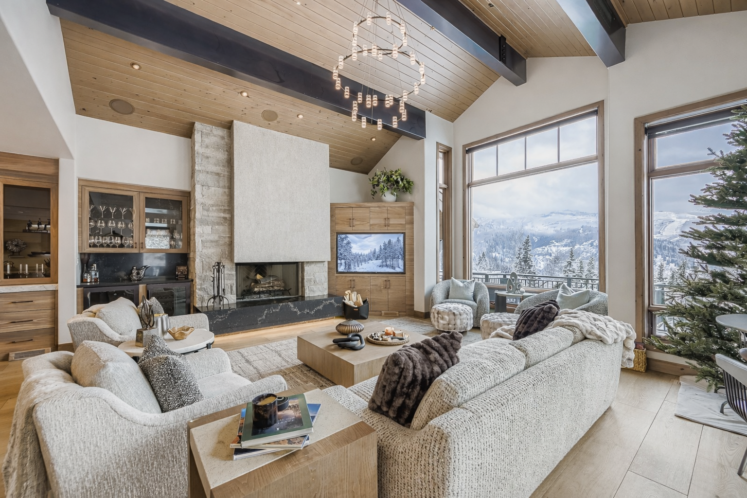 Sink into plush sofas by your crackling fireplace while breathtaking mountain views fill floor-to-ceiling windows.