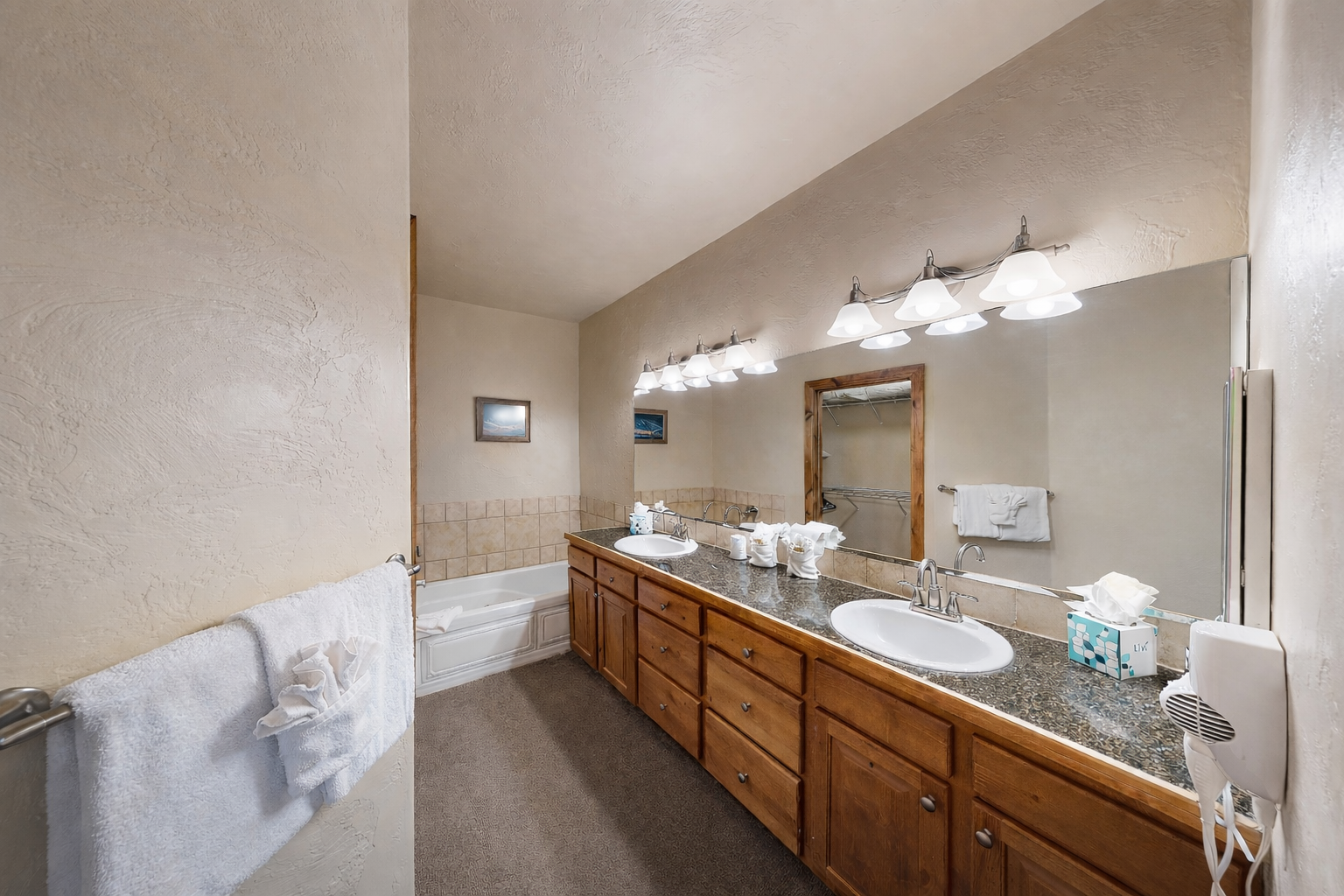 Spacious bathroom featuring a convenient double vanity and a relaxing tub/shower combination. Enjoy ample counter space, storage, and lighting for a seamless morning routine!