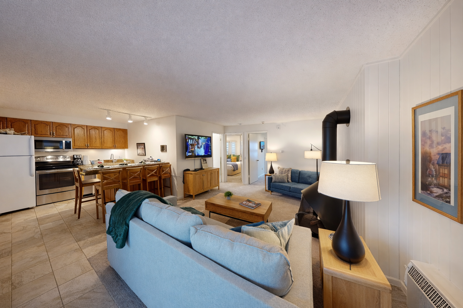 Unwind in your spacious open-concept retreat where comfort meets convenience—plush seating, full kitchen, and warm lighting create the perfect home base.