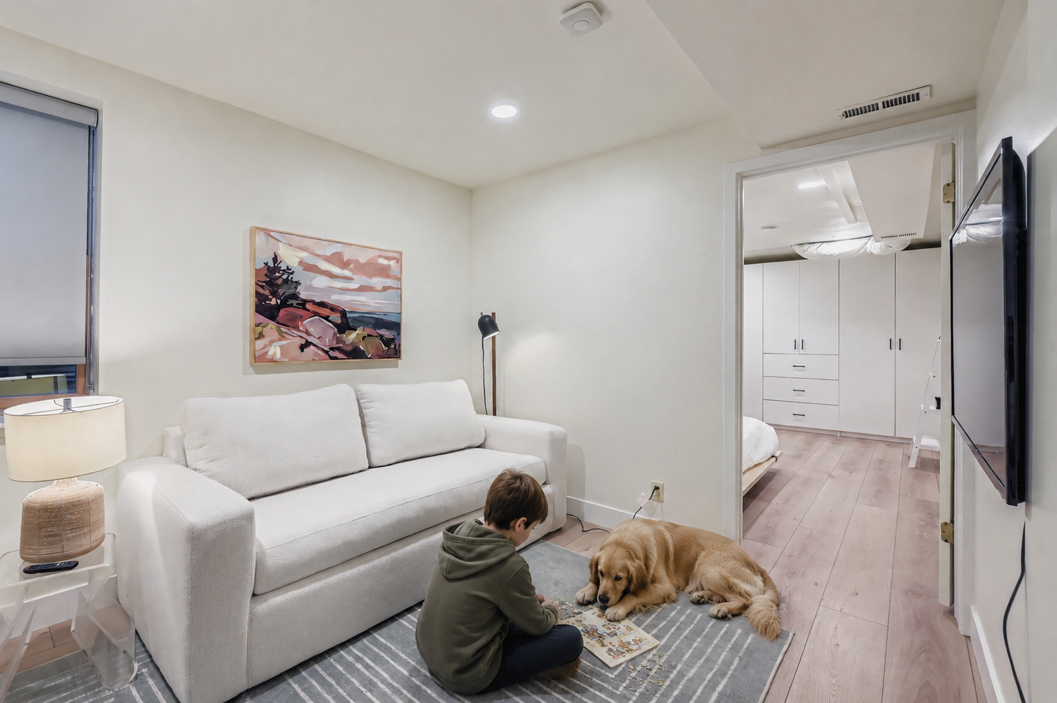 Sink into your private retreat with a plush sofa perfect for morning coffee or evening relaxation. The warm wood floors and calming artwork create a peaceful atmosphere where you can truly unwind.