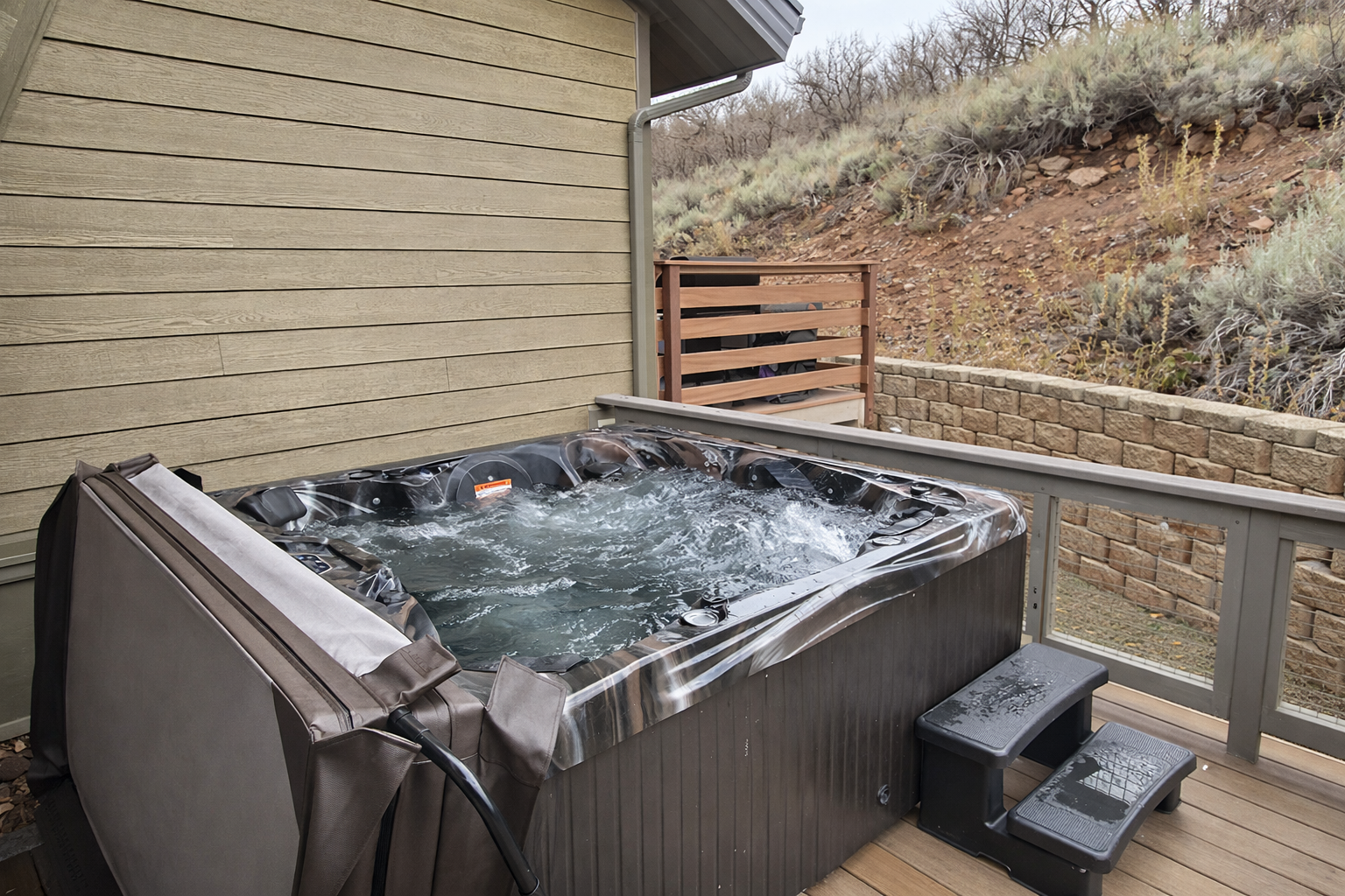 Unwind in your private hot tub, where warm bubbling waters and desert hillside views create the perfect retreat for relaxation.