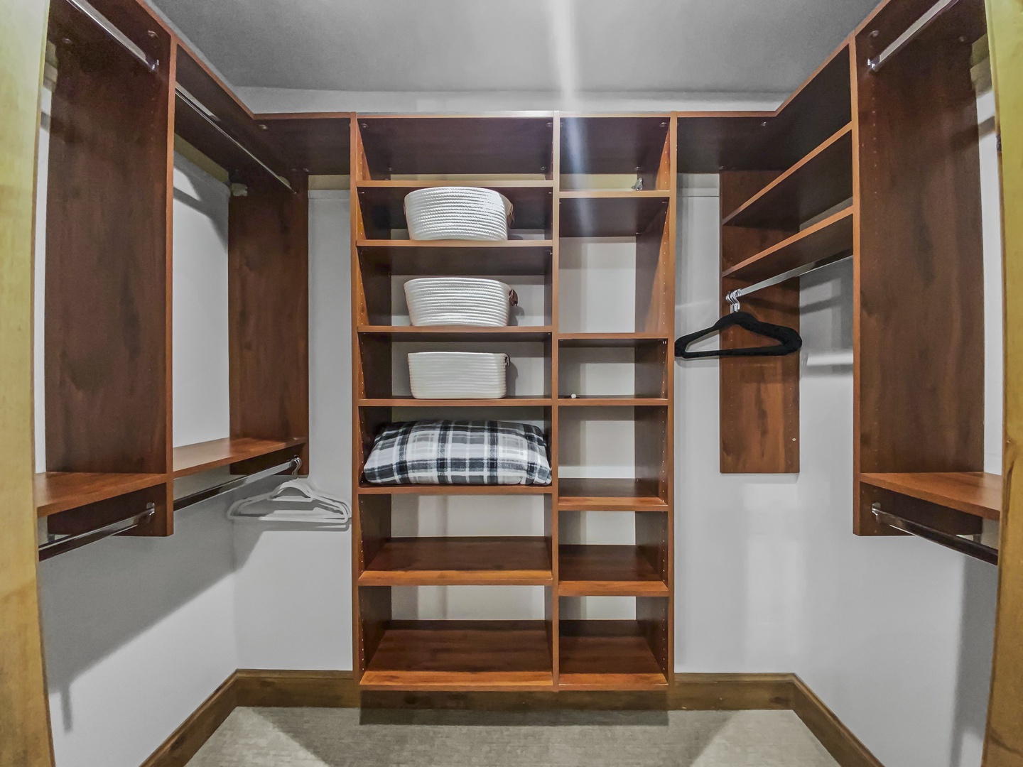 Your personal walk-in closet offers generous hanging space, shelving, and basket storage—a well-organized retreat for all your vacation essentials.