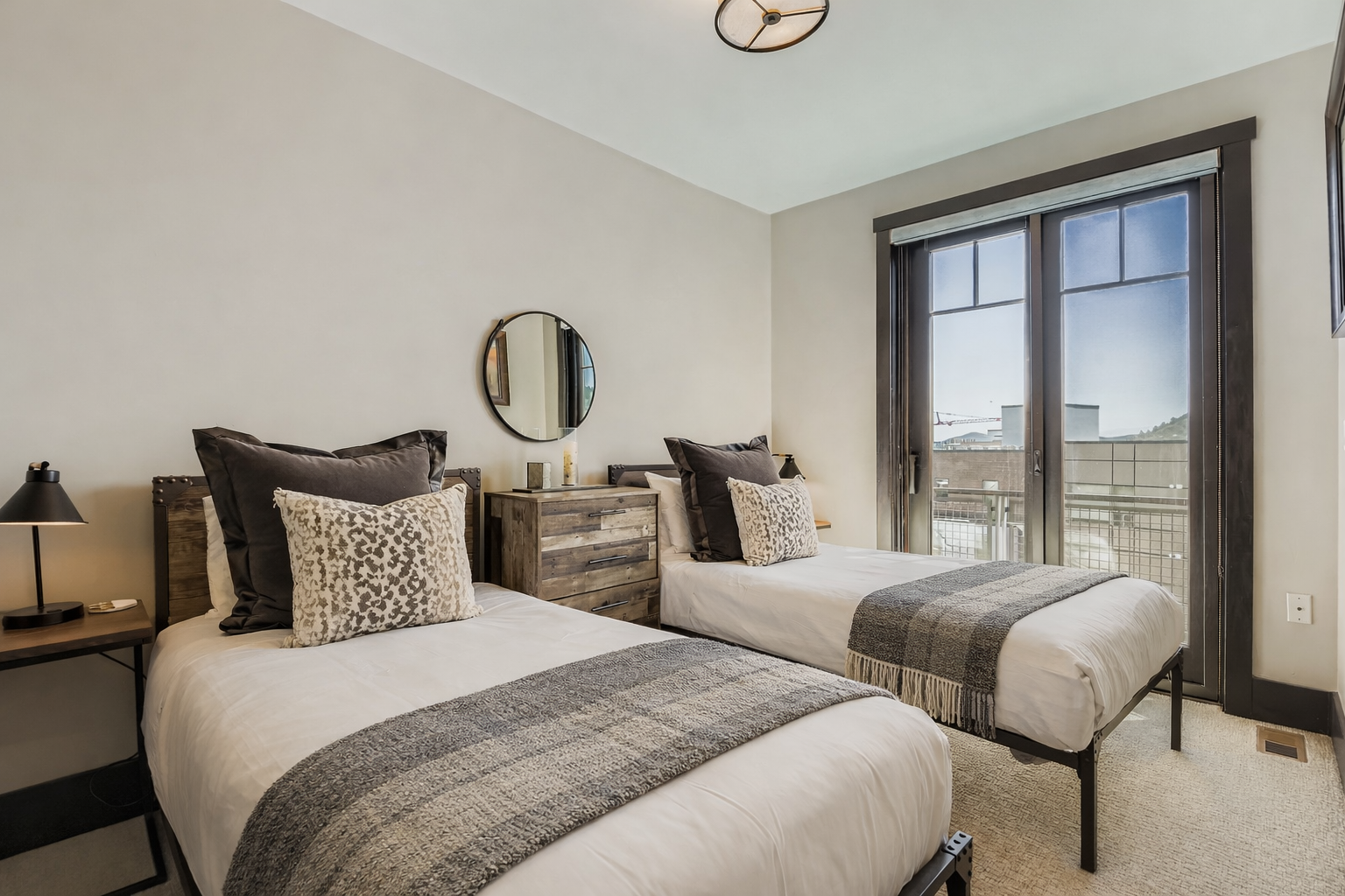 Drift off in comfort with twin beds dressed in plush linens and textured throws, creating your perfect retreat.