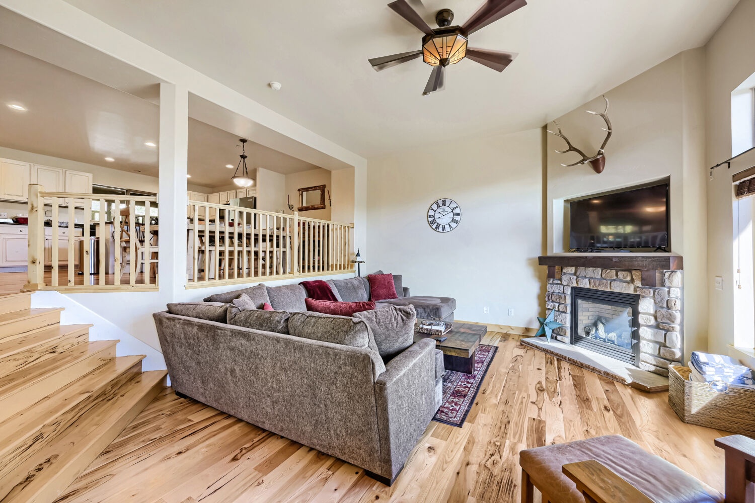 Gather around the cozy stone fireplace and sink into plush sofas—your perfect retreat for mountain evenings. Rustic charm meets modern comfort with soaring ceilings and warm wood throughout.
