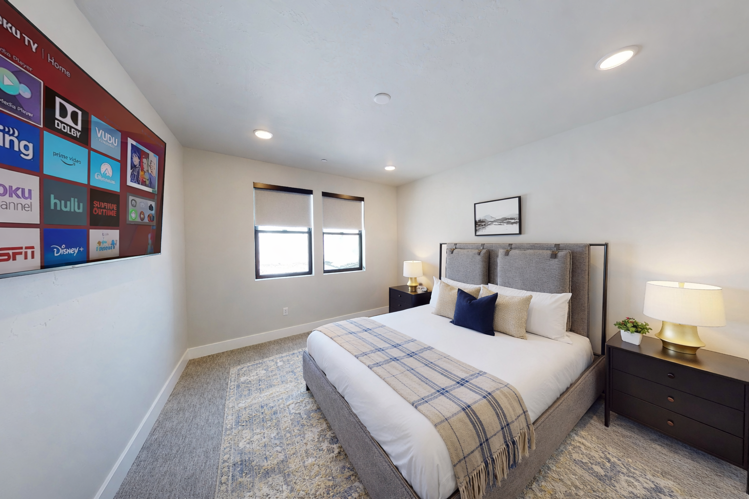 Relax in this serene, contemporary guest suite featuring a plush king-sized bed and a sophisticated upholstered headboard. With soft, neutral tones and a tranquil atmosphere, this room serves as a peaceful sanctuary for rest and recharge.