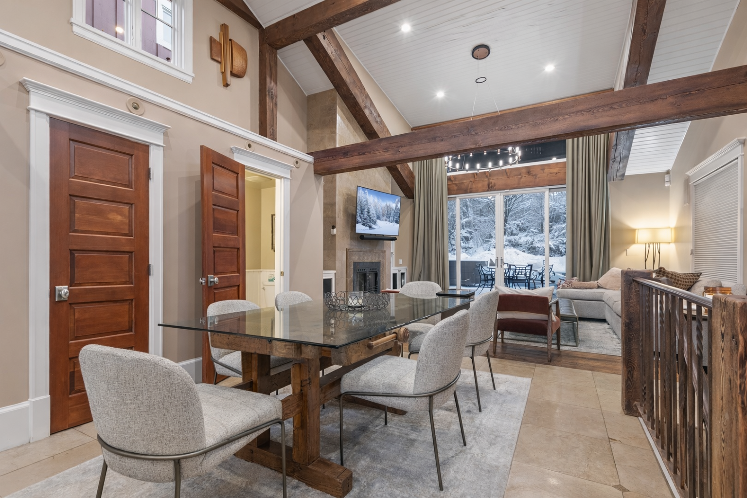 Your elegant dining space features soaring vaulted ceilings with exposed beams, creating an airy yet intimate atmosphere for memorable meals.