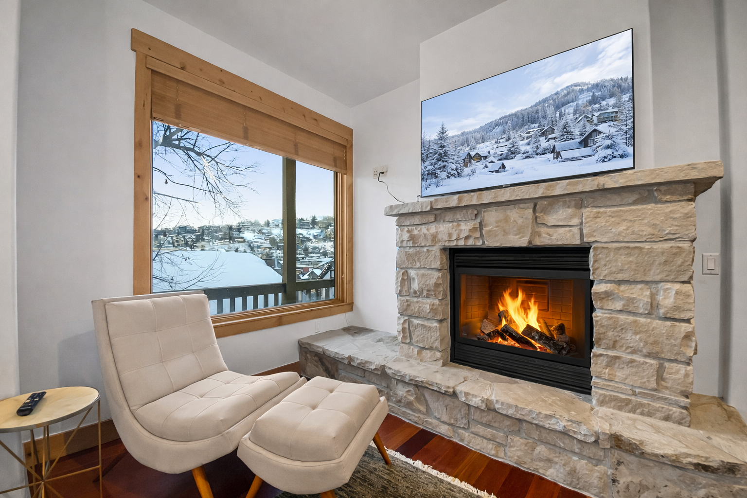 Relax by the cozy fireplace and enjoy the stunning snowy views from the large window. This charming space offers the perfect relaxing retreat for your stay in the mountains.