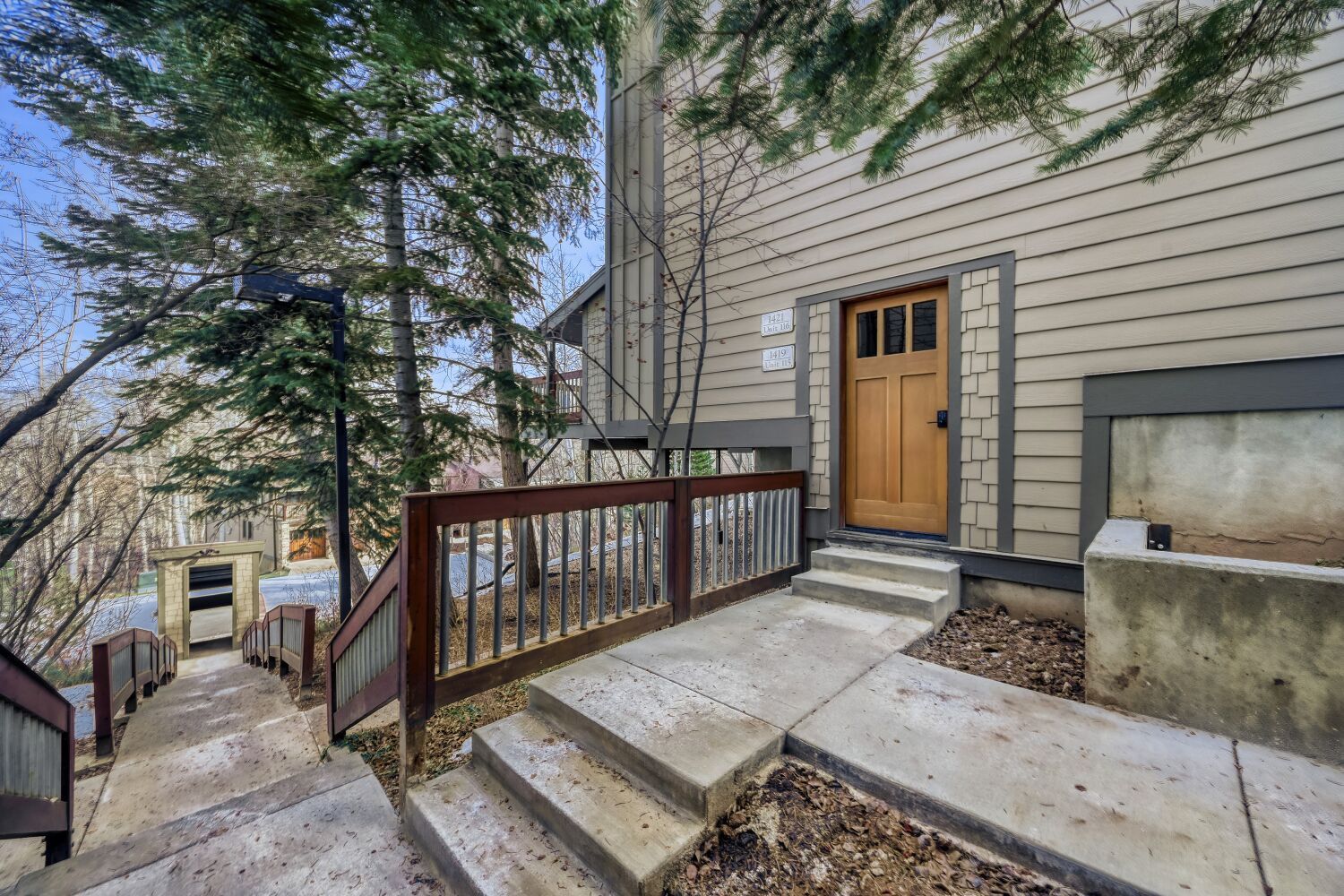 Step into your inviting mountain townhome through this private entrance and deck. The rustic wood accents create a charming first impression for your perfect getaway.