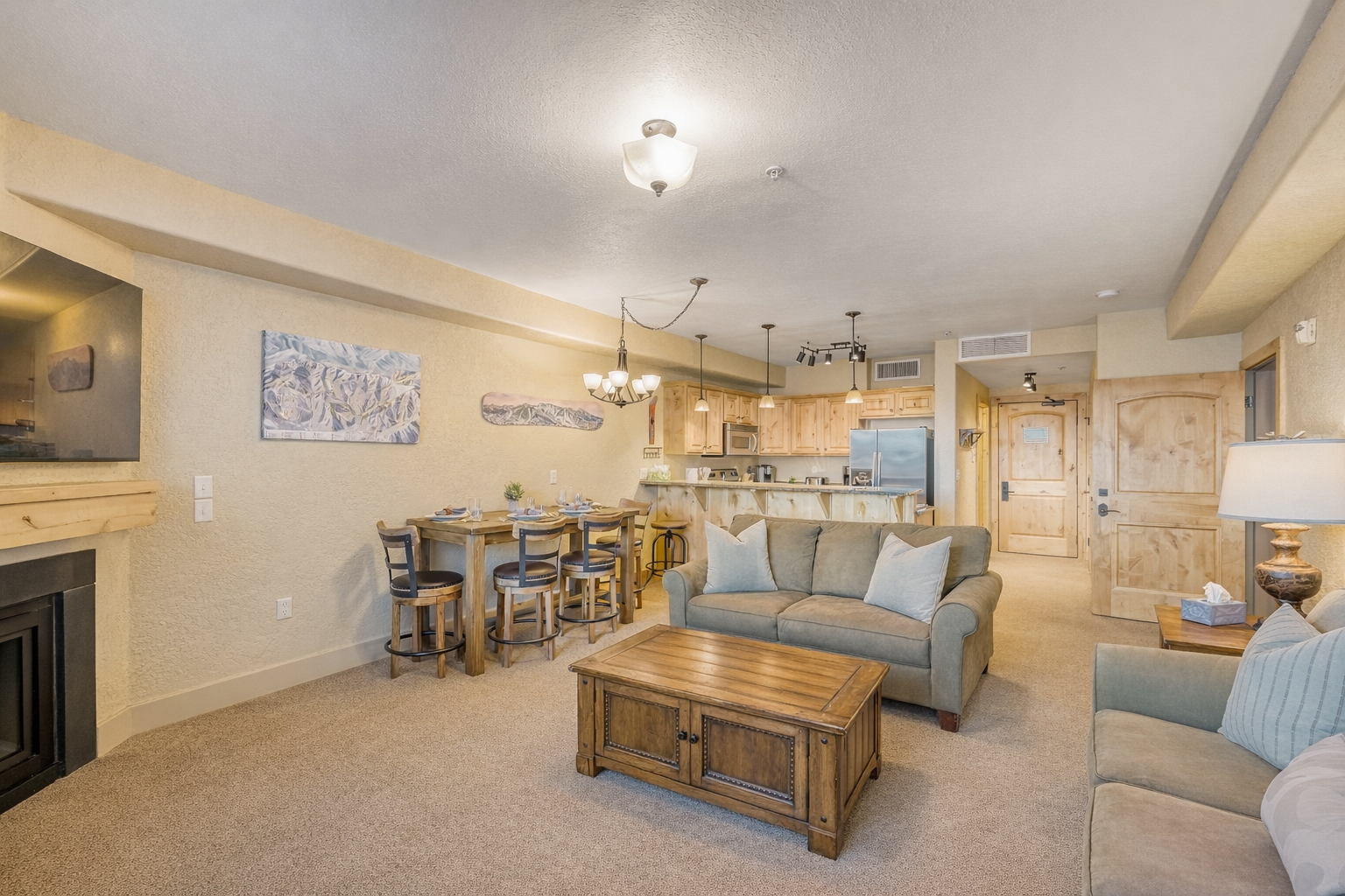 Unwind in your spacious living area where warm wood accents and cozy seating create the perfect atmosphere for relaxation after mountain adventures.