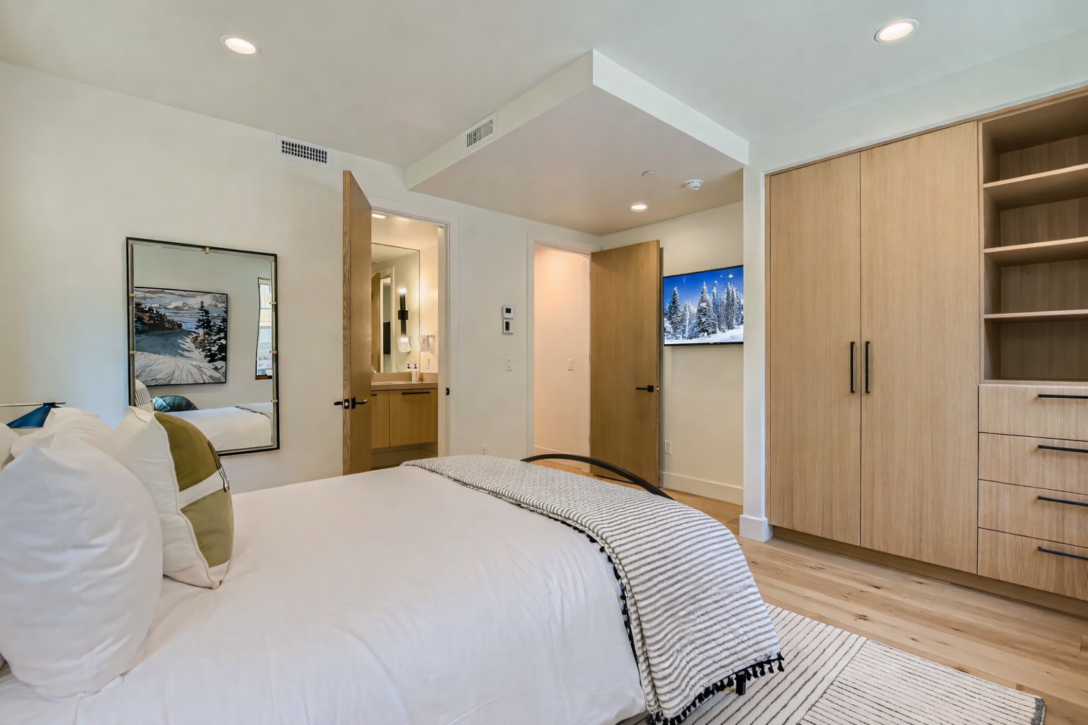 Retreat to the charming queen guest room featuring a cozy bed, stylish decor, and a convenient, modern ensuite bathroom.