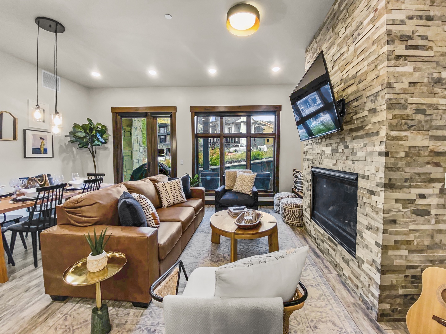 Sink into plush leather sofas beside a glowing fireplace, where mountain views on the screen and warm lighting invite you to unwind in modern comfort.