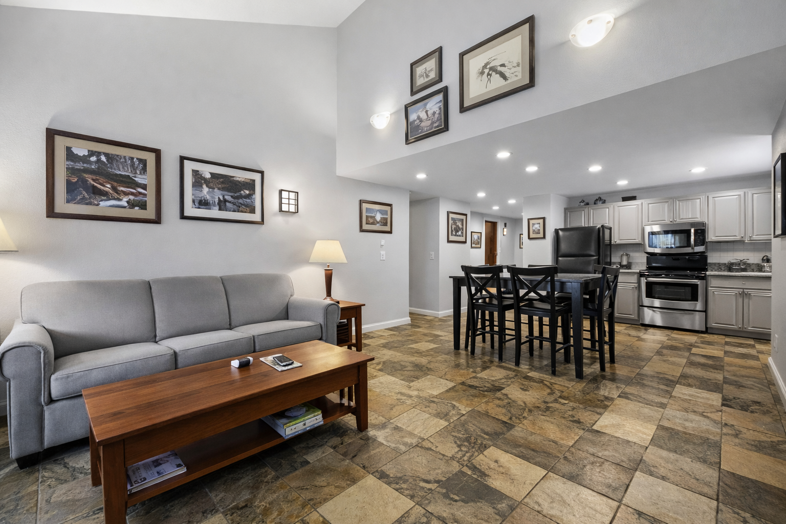 Open-concept living area with a modern fully-equipped kitchen, dining space, and comfortable seating. Perfect for socializing and unwinding after a day on the slopes.