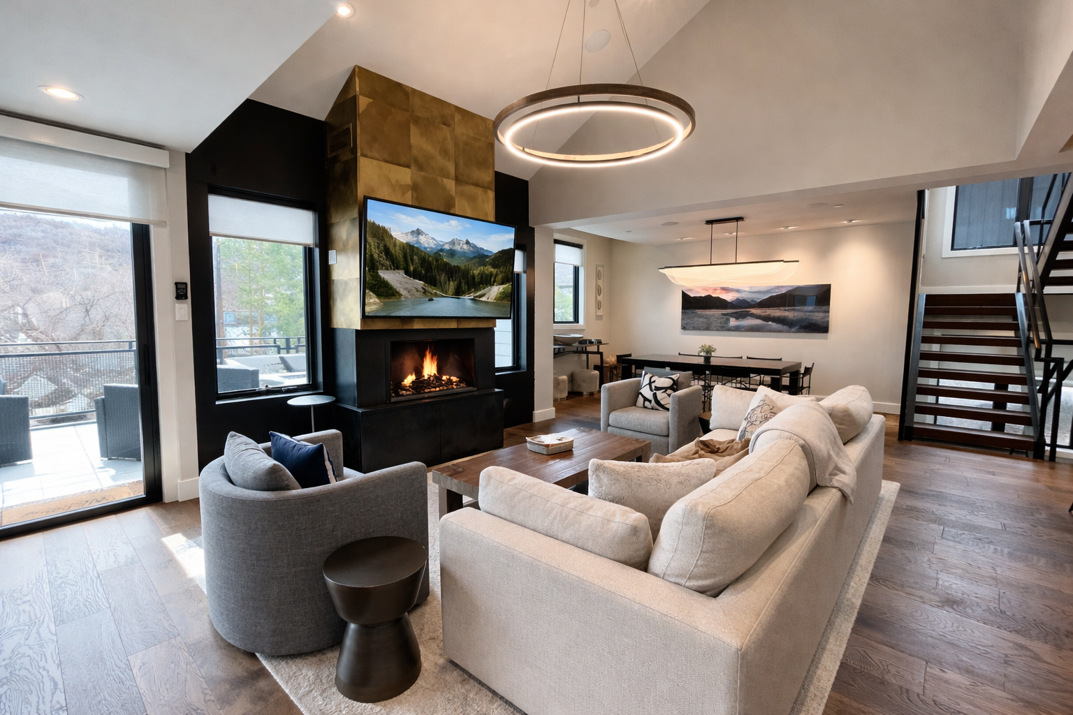 Unwind in the open-concept living area featuring a striking gold fireplace, vaulted ceilings, and comfortable seating