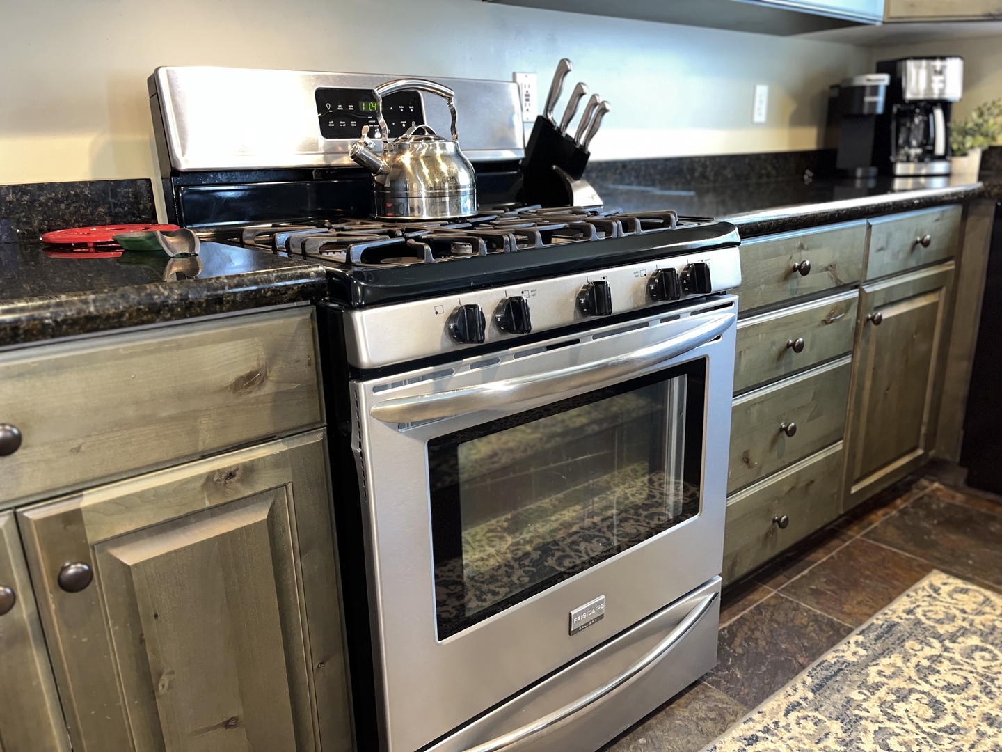 Cook your favorite meals in this fully-equipped kitchen featuring stainless steel appliances, granite countertops, and ample cabinet space for all your culinary adventures.