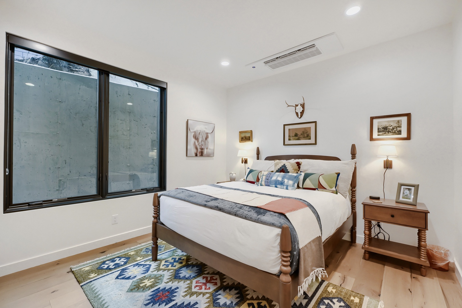 Slip into this cozy bedroom where rustic charm meets modern comfort. Clean lines, a beautifully crafted bed, and warm touches invite your most restful night's sleep.