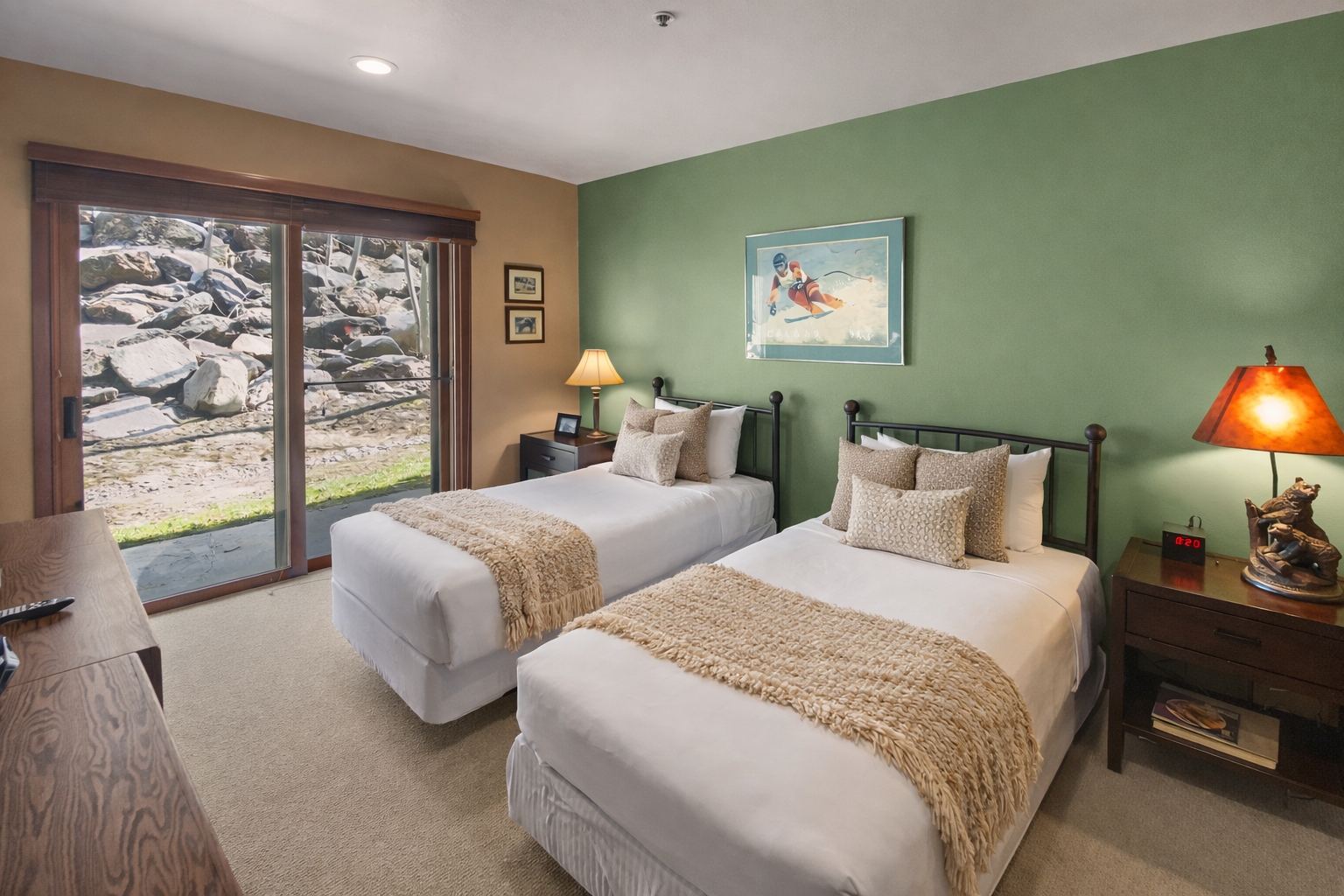Your cozy twin bedroom features crisp linens, warm earth tones, and a peaceful stone garden view through sliding doors.