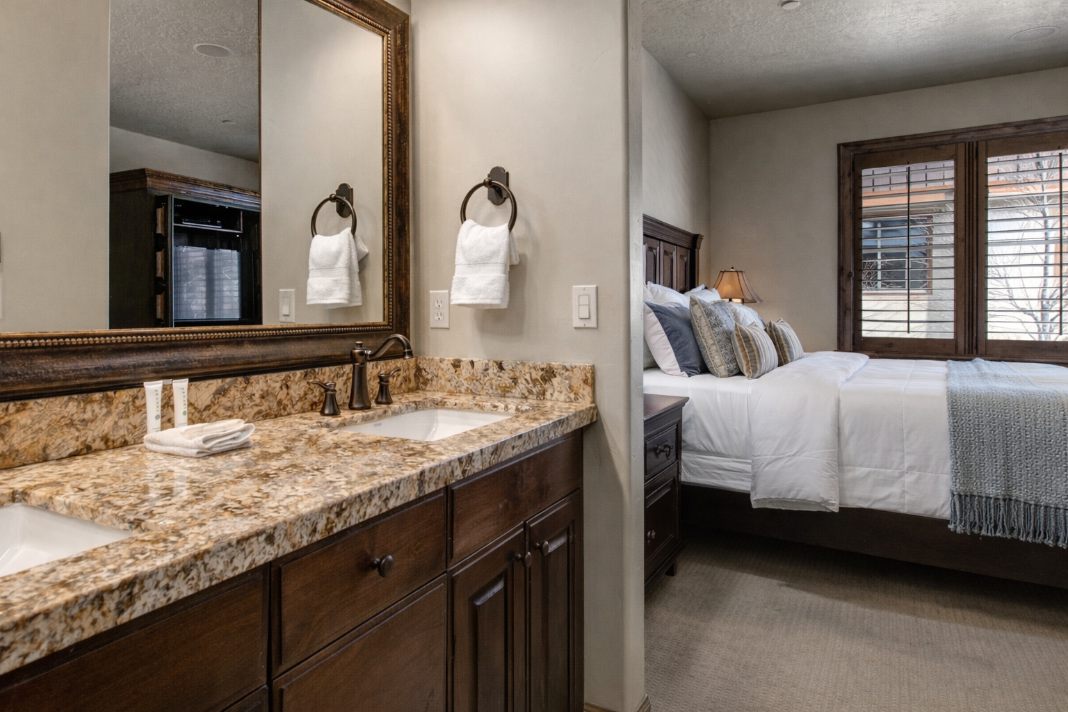 This sophisticated en-suite offers a beautiful granite vanity and dark wood cabinetry just steps from the bedroom. It’s a seamless blend of convenience and mountain-chic luxury for your stay.