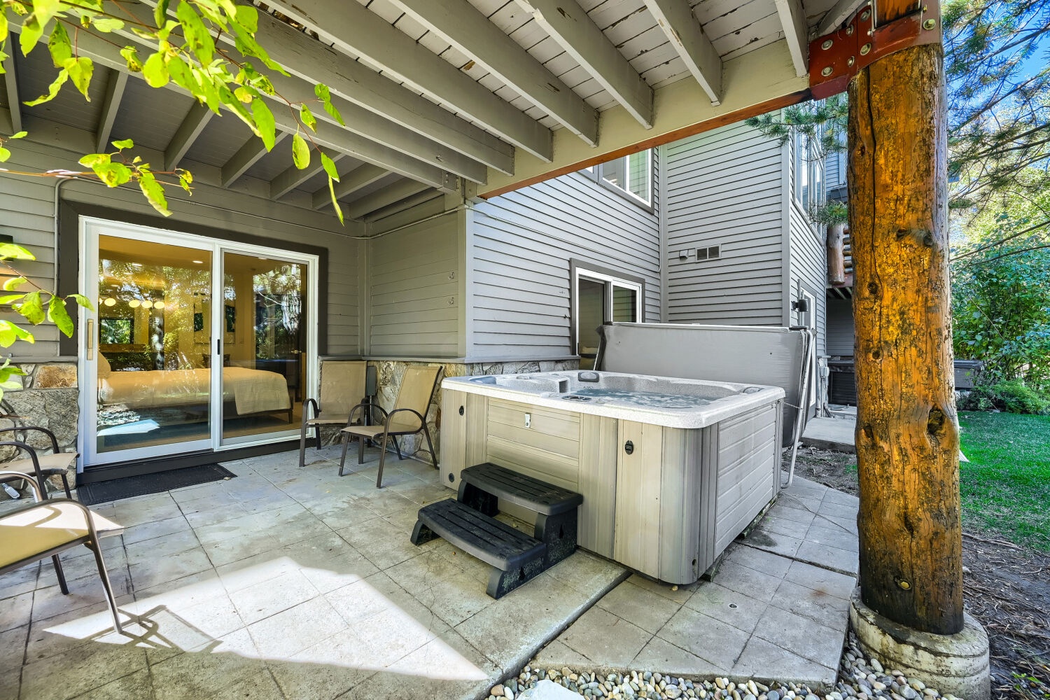 Slip into your private hot tub and let the day's stresses melt away on this peaceful, covered patio surrounded by pine trees.