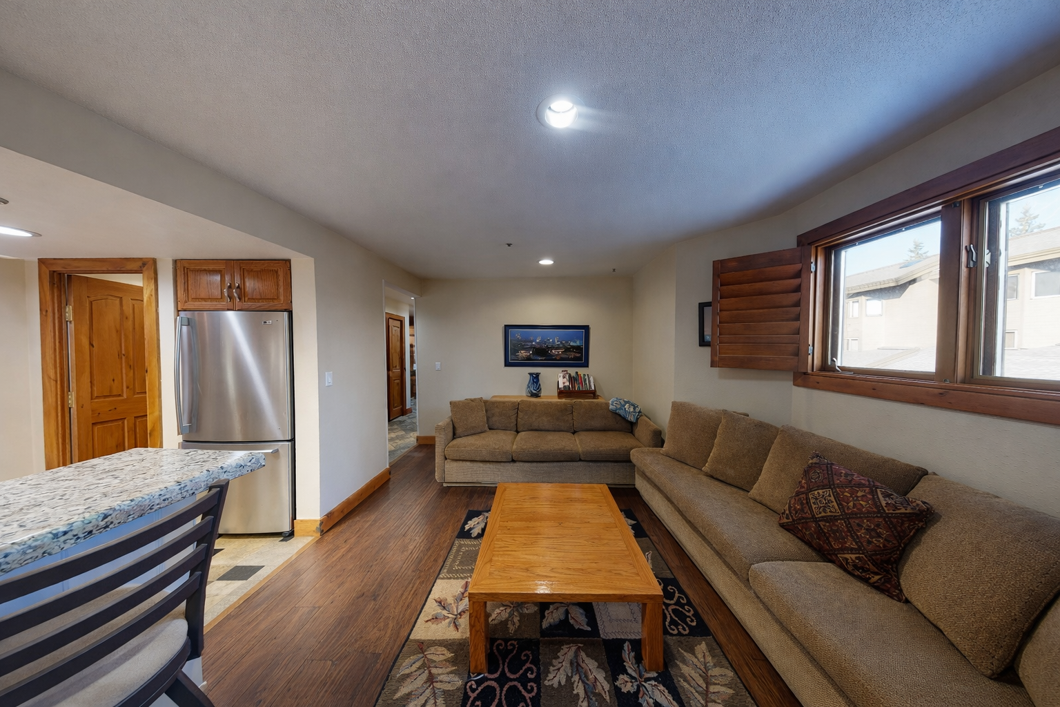 Enjoy the cozy living room's plush sectional and rustic wooden coffee table, perfect for relaxing after a day of exploring Park City.