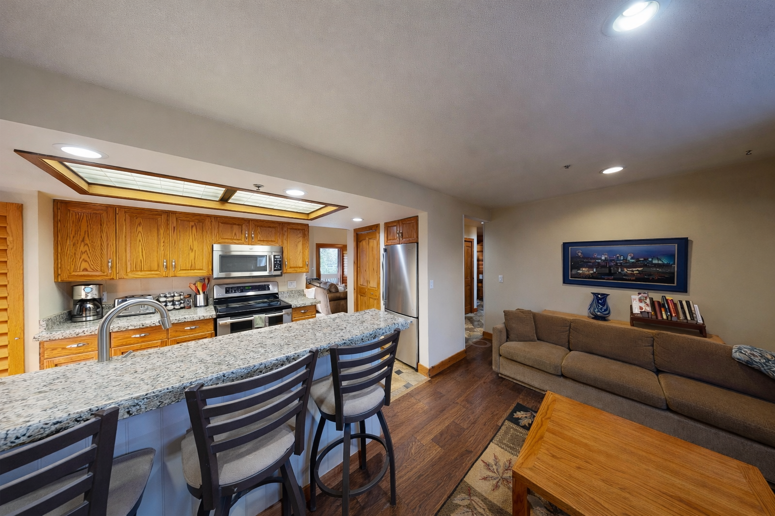 Enjoy this open-concept living area with a fully equipped kitchen, a large island, and comfortable seating