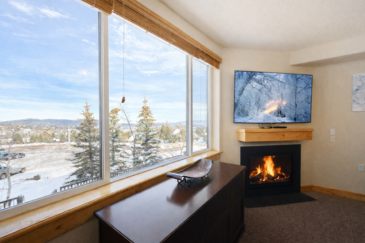 Cozy up by your crackling fireplace while enjoying stunning winter vistas through panoramic windows in this peaceful retreat.