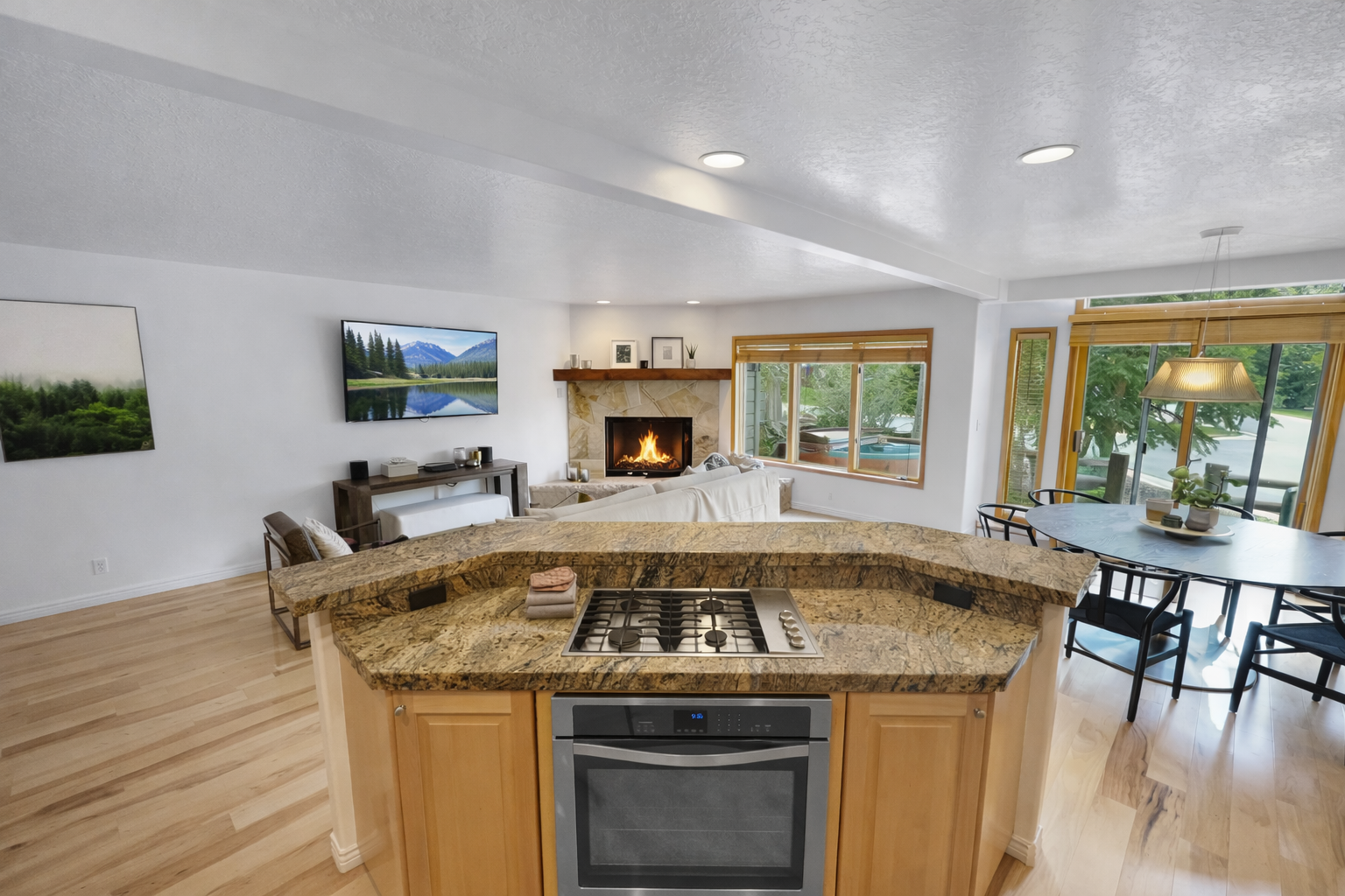 This fully equipped kitchen features stunning granite countertops, modern stainless steel appliances, and a convenient island, perfect for preparing meals during your stay.