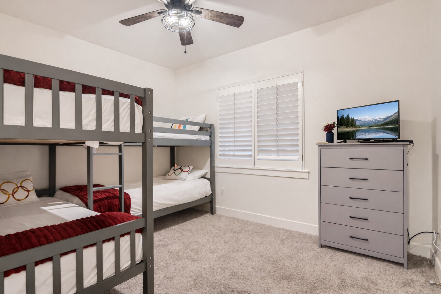Your kids will love this cozy bunk room with fun decor, ceiling fan for comfort, and entertainment center for movie nights together.