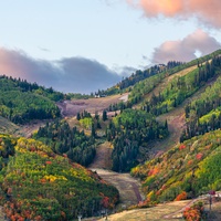 Rolling hills and valleys showcase vibrant autumn colors in the surrounding countryside landscape.