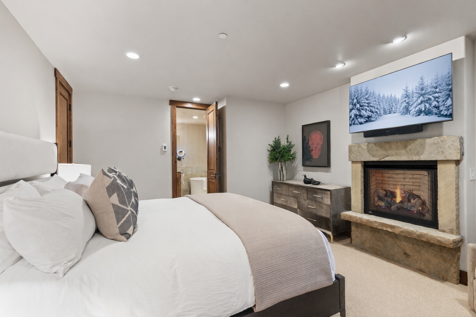 Drift off to sleep beside your crackling fireplace, watching winter scenes on the wall-mounted TV in your sophisticated bedroom suite.