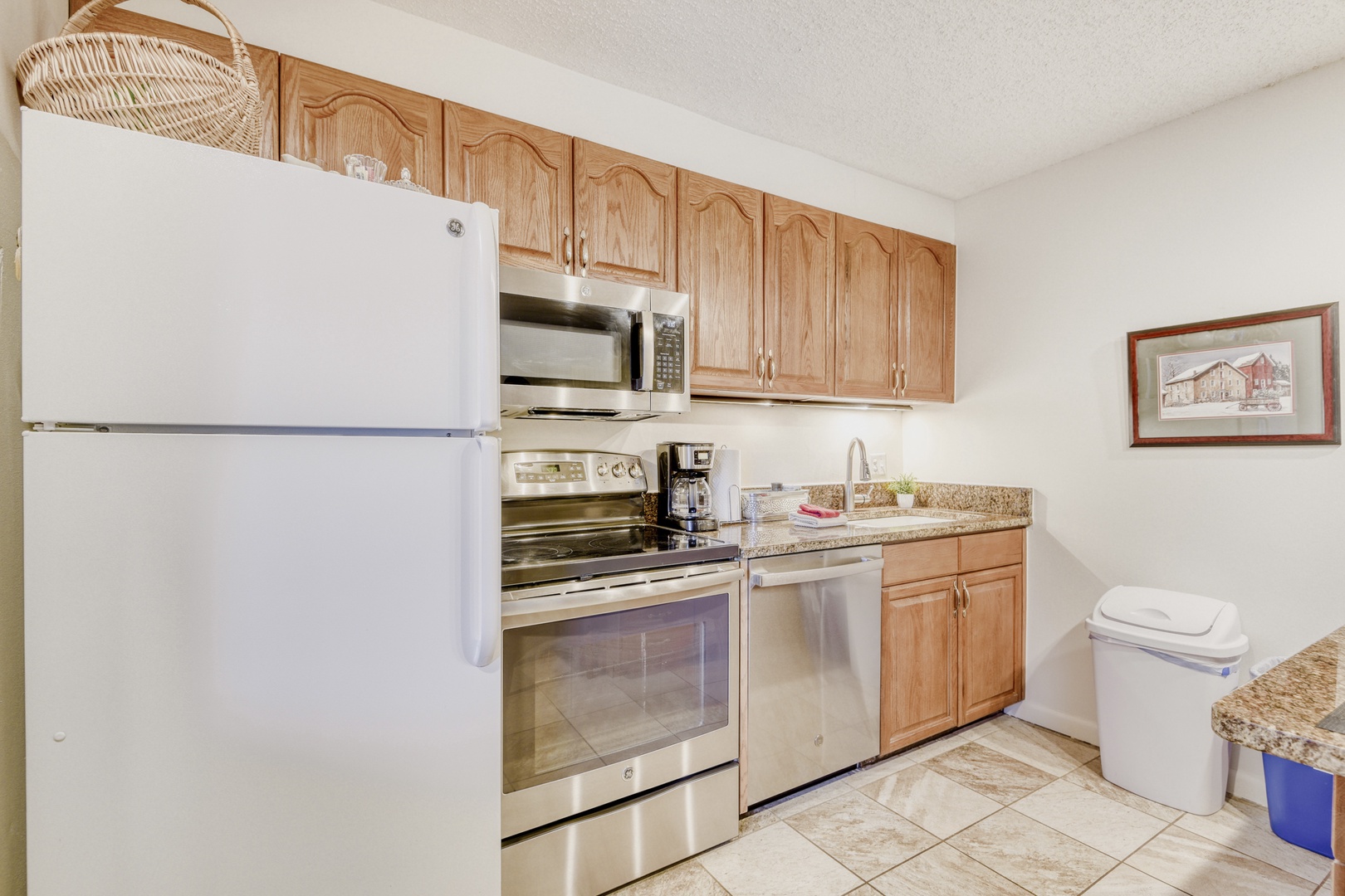 Your fully equipped kitchen awaits with granite counters, stainless appliances, and warm wood cabinets for easy home-cooked meals.