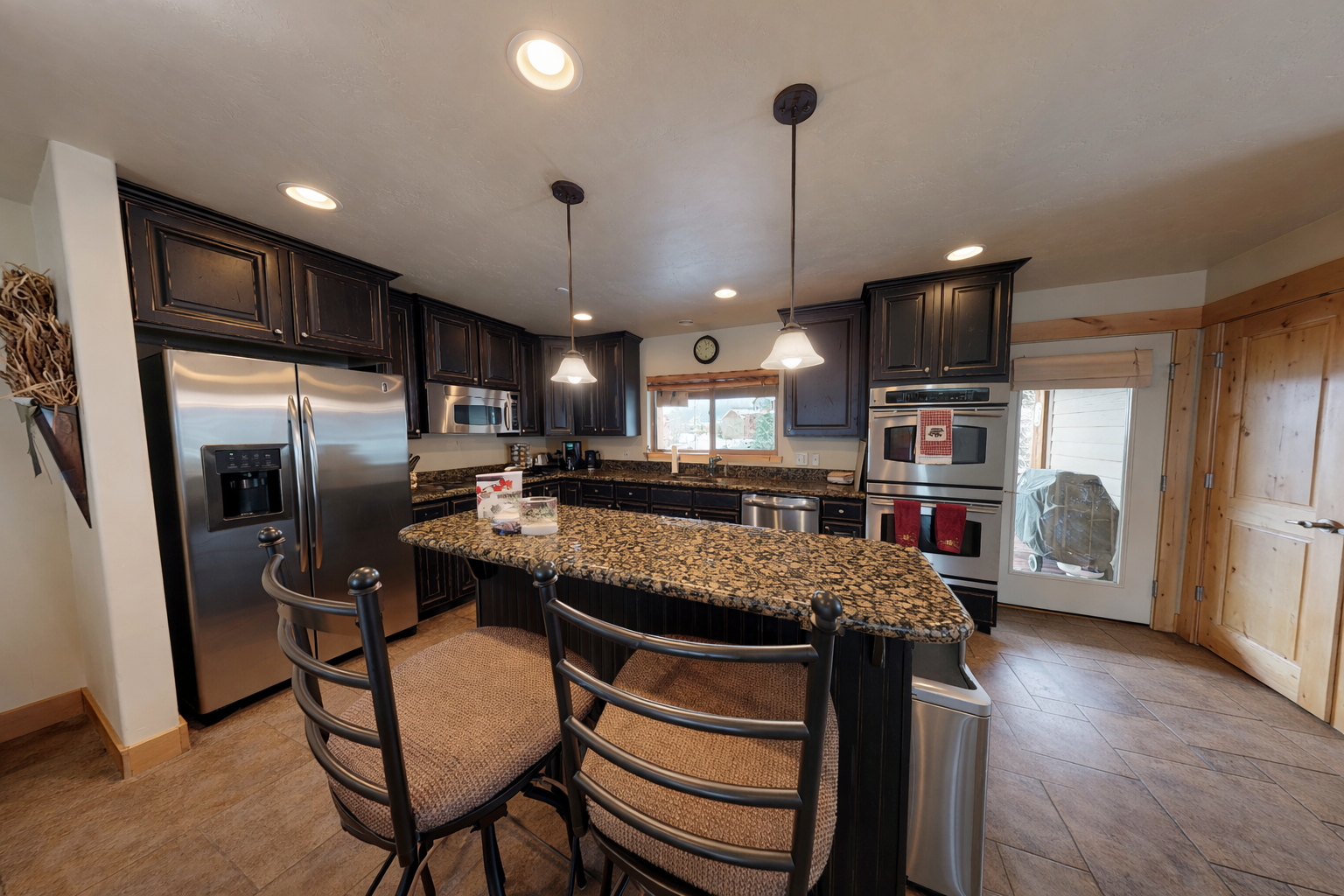 Your spacious kitchen features granite countertops, stainless steel appliances, and a curved island perfect for morning coffee or evening meals.