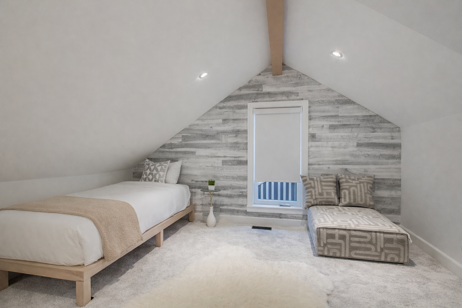 Unwind in your cozy attic retreat with twin beds and charming geometric patterns creating the perfect peaceful escape.