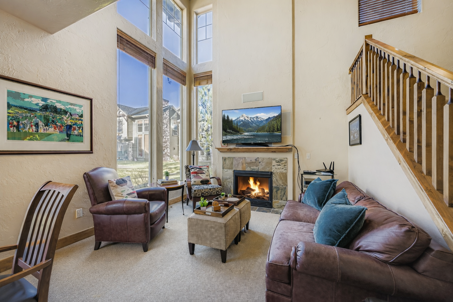 Unwind in this spacious living room with rich leather seating, a cozy fireplace, and entertainment center - your perfect home base for relaxation.