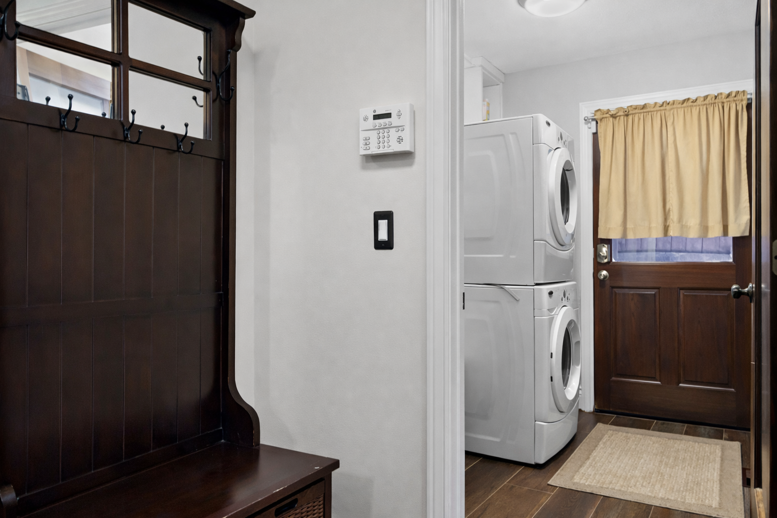 Your dedicated laundry room features full-size washer and dryer with convenient bench seating for sorting clothes in comfort.